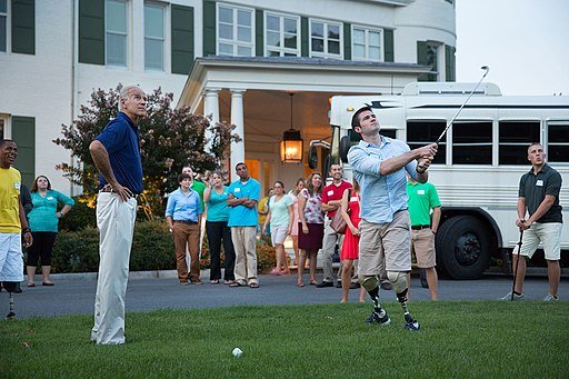Vice President Joe Biden watches First Lieutenant Jason Church as he hits a birdieball, during a barbecue for Wounded Warriors and their families, at the Naval Observatory Residence. Public Domain.