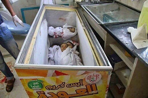 Children buried in a refrigerator in Gaza. Author unknown. Public domain.