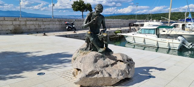 Fisherman statue at Njivice on island Krk,  Croatia