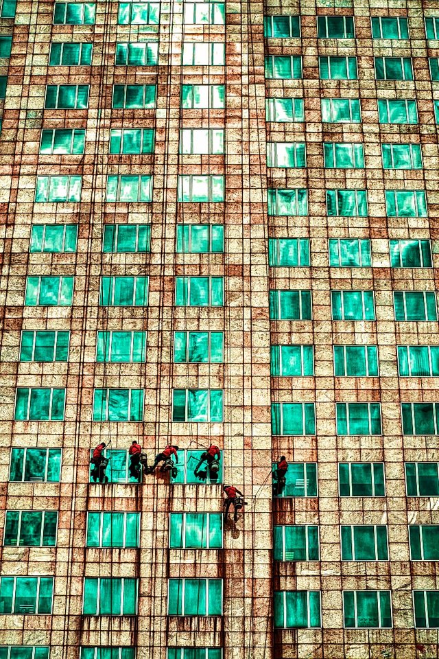 cleaning windows on skyscraper