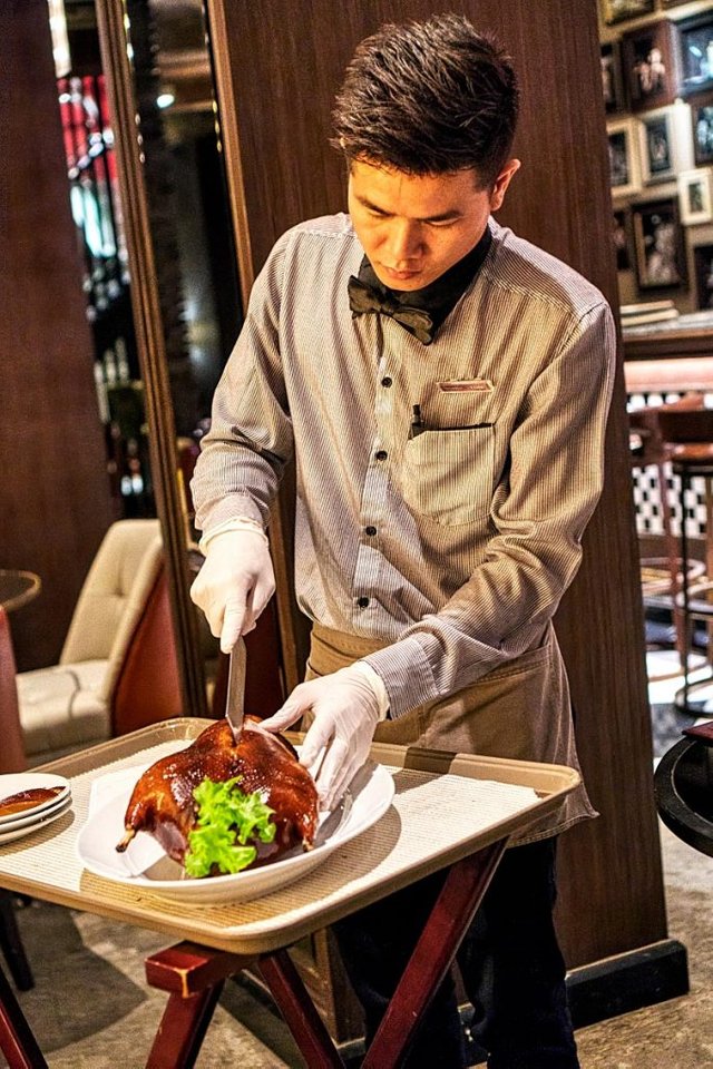 Chef carving Peking duck