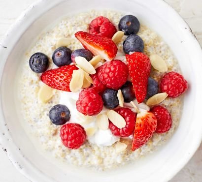 A bowl of porridge topped with fruits