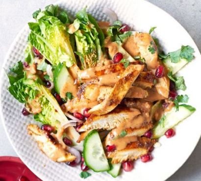 Chicken satay pieces with salad leaves