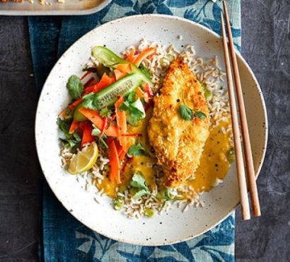 Plate with katsu curry served over rice with a side salad