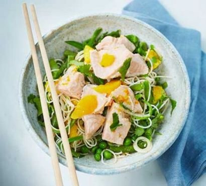 Salmon and noodle salad in a bowl with chopsticks