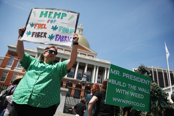 Amy Flagg holds up a sign to support hemp rights.