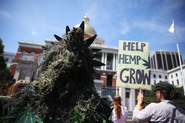 Potsquatch, also known as Dave Mech, left, listens to the MASS Hemp Coalition as they hold a press conference Monday.