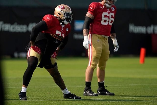 San Francisco 49ers' Trent Williams, left, stretches during NFL football practice in Santa Clara, Calif., Tuesday, Aug. 18, 2020.
