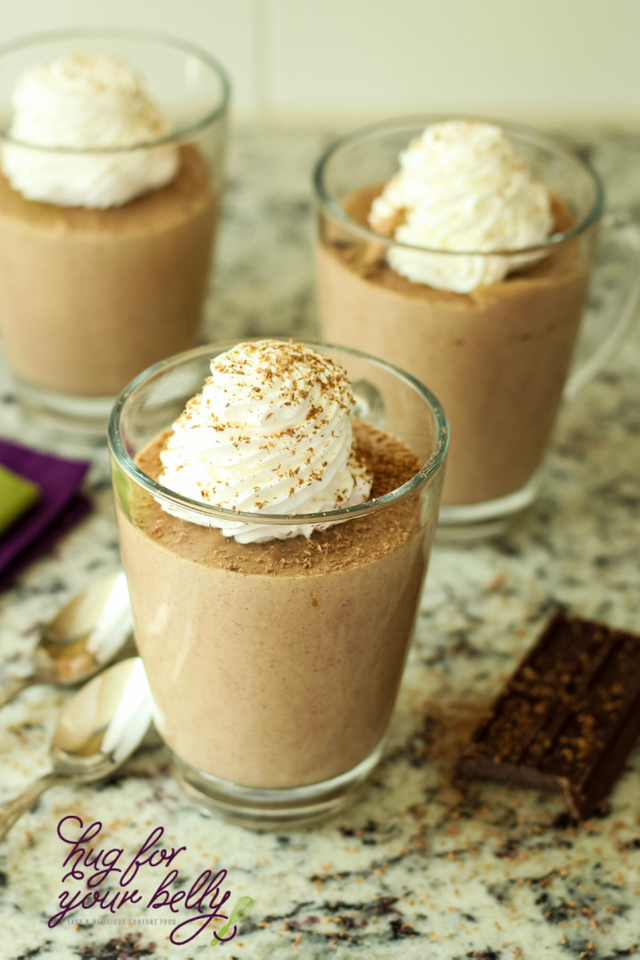 chocolate panna cotta dessert in glass topped with whipped cream