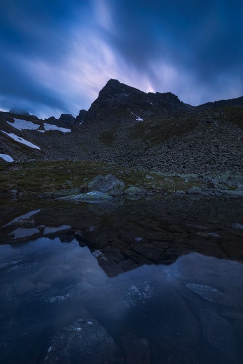 A tranquil pond in the mountains with the Rinnenspitze reflected in it