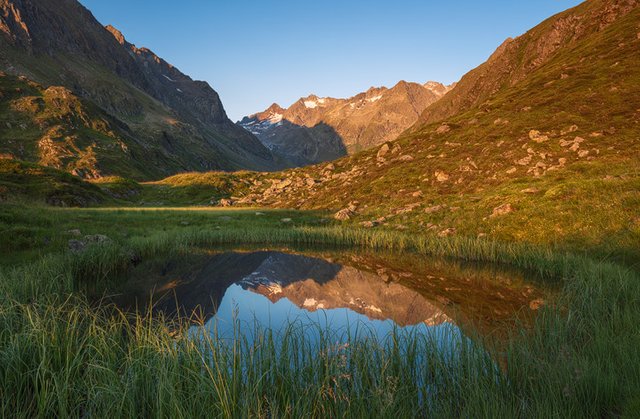 Reflection of the Stubai Mountains in a little lake