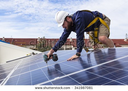 stock-photo-solar-panel-technician-with-drill-installing-solar-panels-on-roof-341987081106e0.jpg