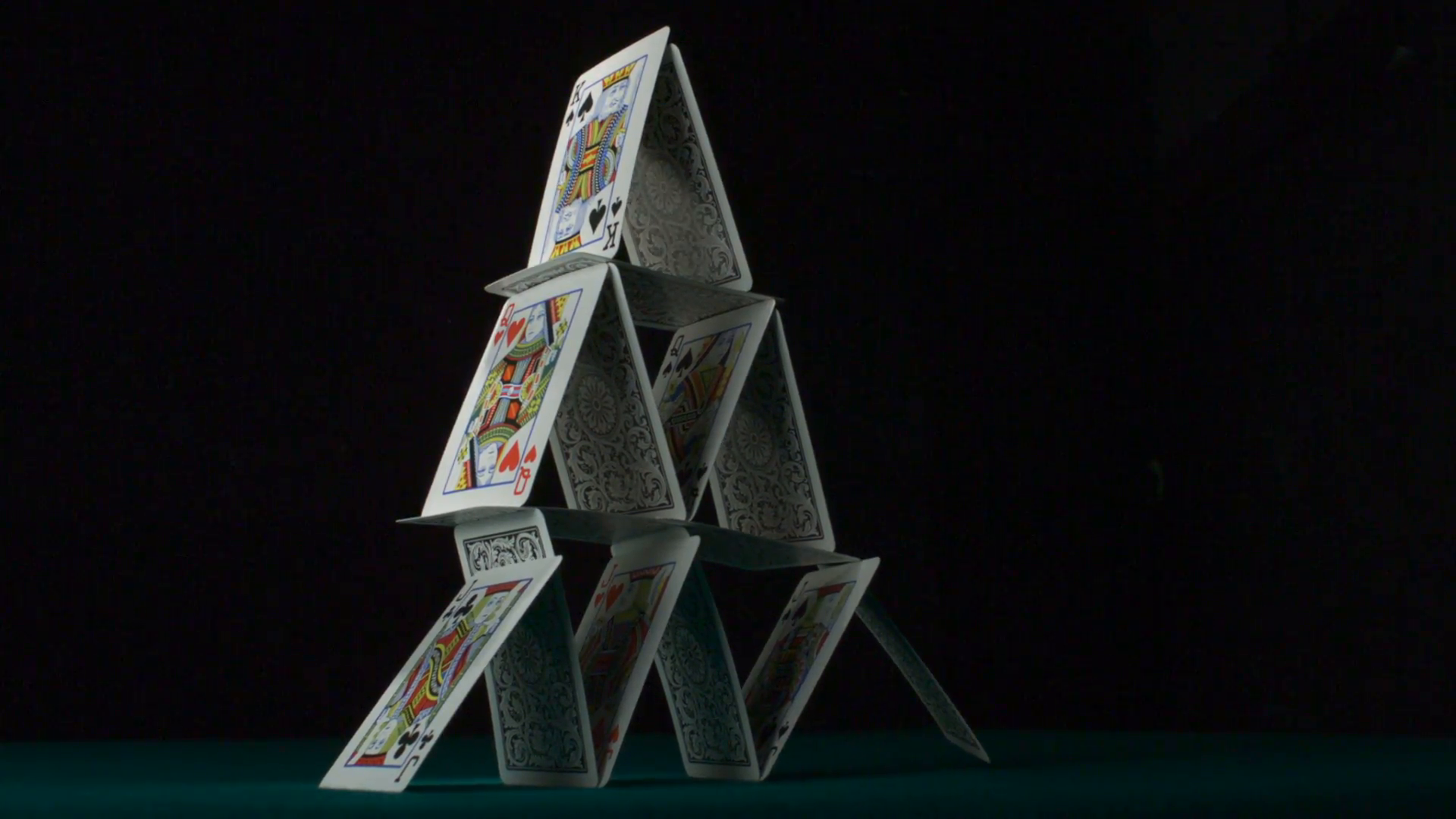 pyramid-house-of-playing-cards-falling-down-slow-motion_nyw3tndeg__F0000.png