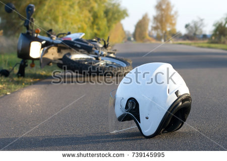 stock-photo-photo-of-helmet-and-motorcycle-on-road-the-concept-of-road-accidents-739145995.jpg