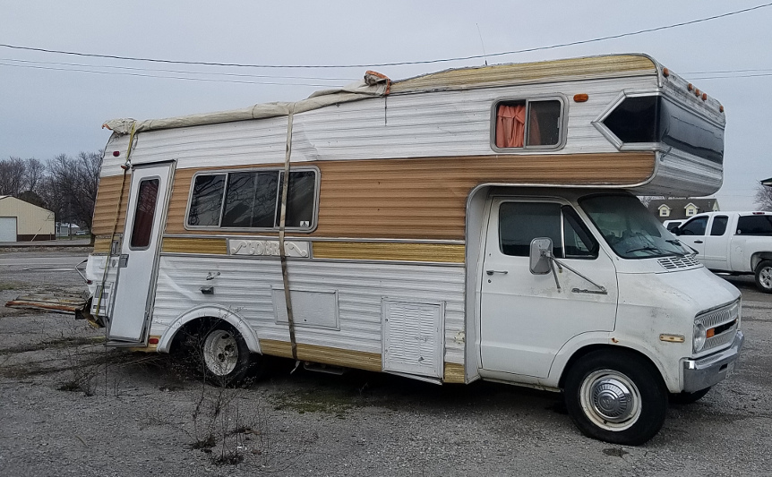 A smashed up camper from the front passenger's side corner