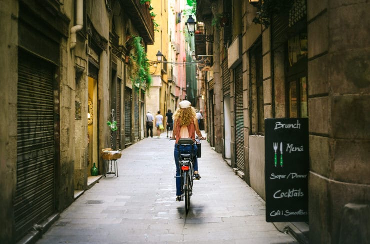 Riding-bicycle-through-old-street-of-Barcelona.jpg