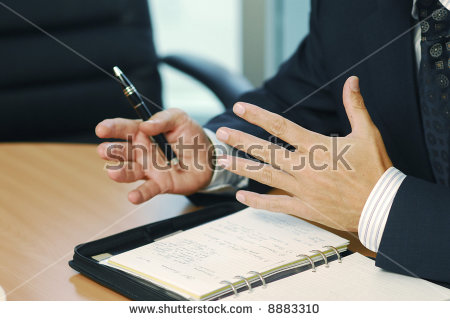 stock-photo-a-businessman-with-pen-doing-gesticulation-8883310.jpg