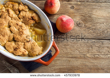 stock-photo-homemade-peach-cobbler-crumble-in-baking-dish-over-rustic-wooden-background-457933978.jpg