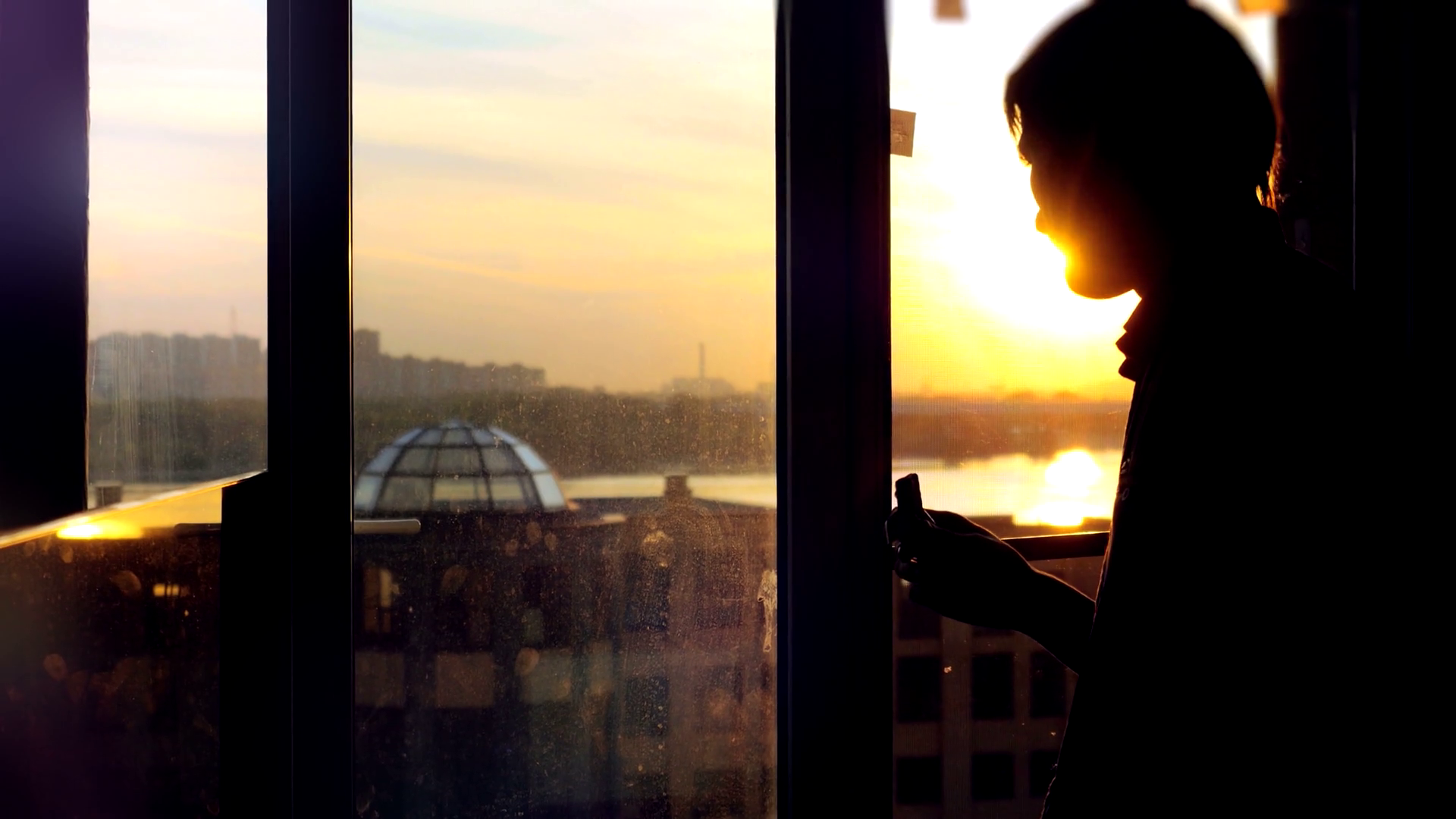 back-view-of-young-man-sitting-on-window-with-coffee-cup-has-a-breakfast-looking-at-dawn-city-scenery-handsome-casual-guy-relaxing-and-watching-sunrise-3840x2160_bpajc76c_thumbnail-full01.png