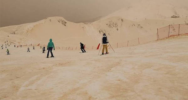 skiers-orange-snow.jpg