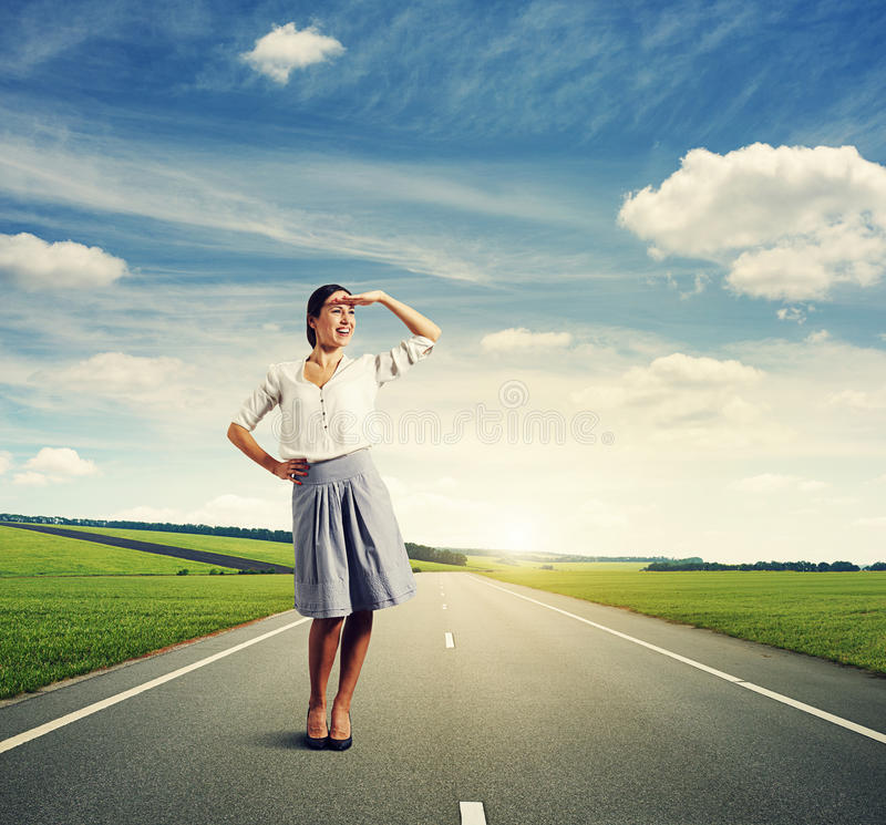 young-woman-looking-distant-smiley-standing-road-37083084.jpg