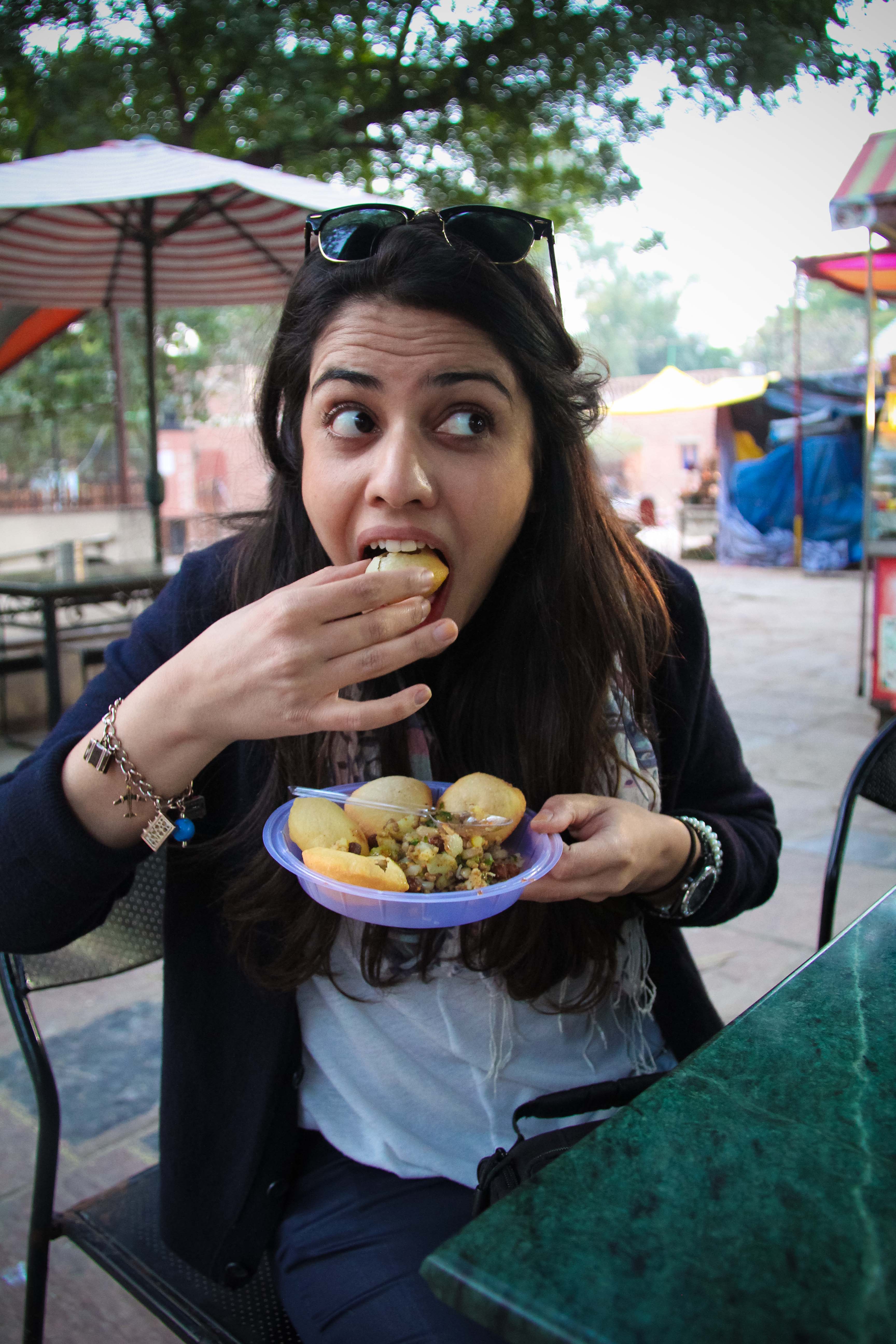 Girls in India love to eat Pani Puri.