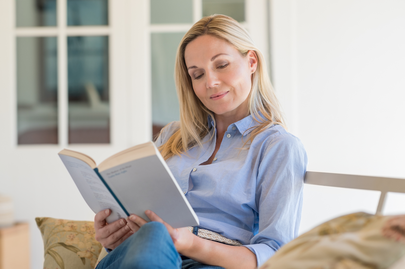 bigstock-Happy-mature-woman-reading-sto-132405563.jpg