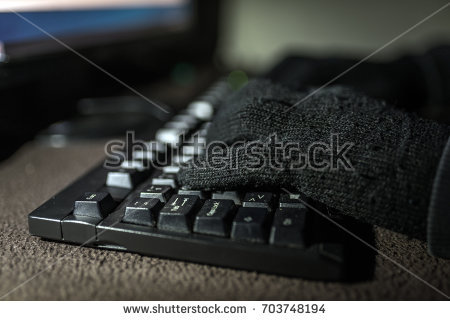 stock-photo-fingers-pressing-on-a-computer-keyboard-in-the-dark-silhouette-black-and-white-hands-of-anonymous-703748194.jpg