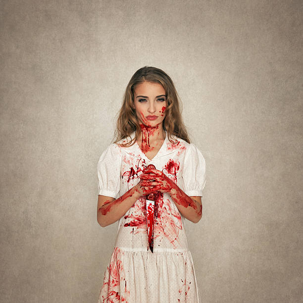 killer-beauty-holding-bloody-knife-picture-id160189505.jpg