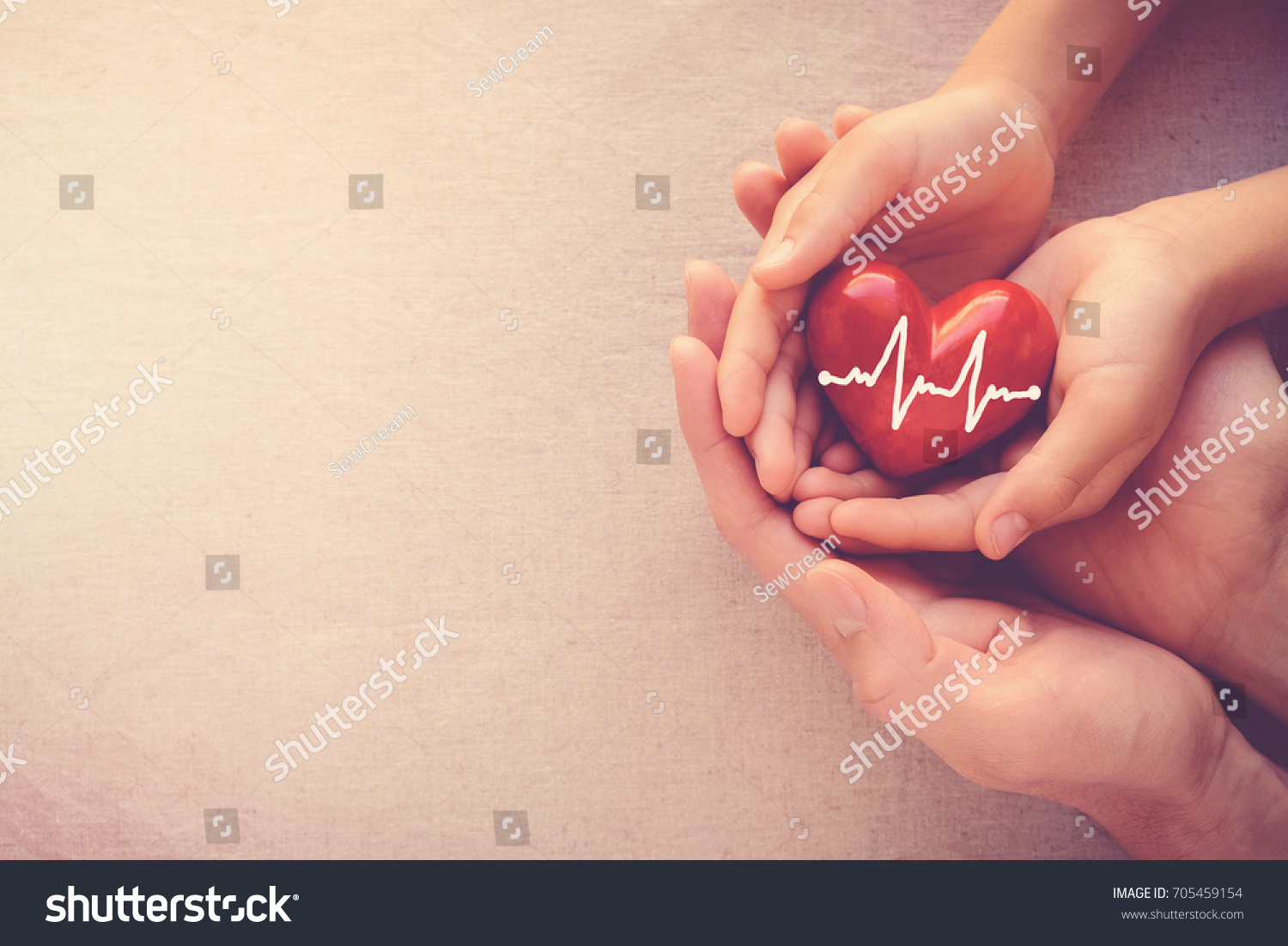 stock-photo-adult-and-child-hands-holding-red-heart-with-cardiogram-health-care-love-and-family-insurance-705459154.jpg