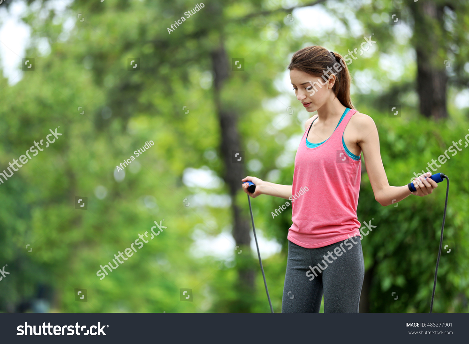stock-photo-young-woman-with-skipping-rope-in-park-488277901.jpg