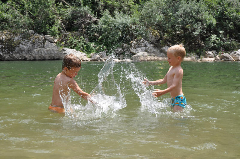 two-boys-playing-water-10306864.jpg