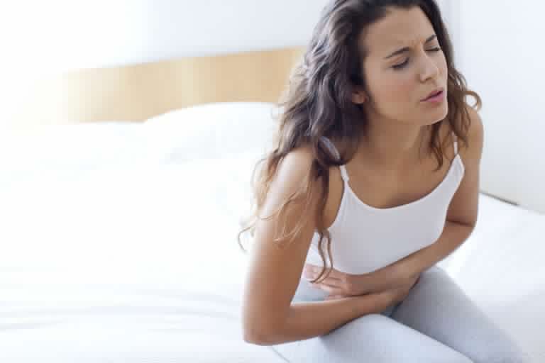 woman-on-bed-with-cramps-623683731-580248355f9b5805c2fad4c7.jpg