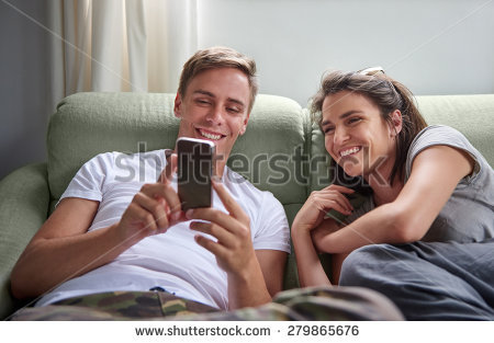 stock-photo-young-laughing-couple-hanging-out-on-their-couch-together-with-the-boyfriend-sharing-funny-stuff-279865676.jpg