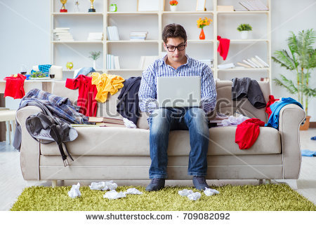 stock-photo-young-man-working-studying-in-messy-room-709082092.jpg