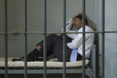 man-sitting-prison-cell-29662873.jpg