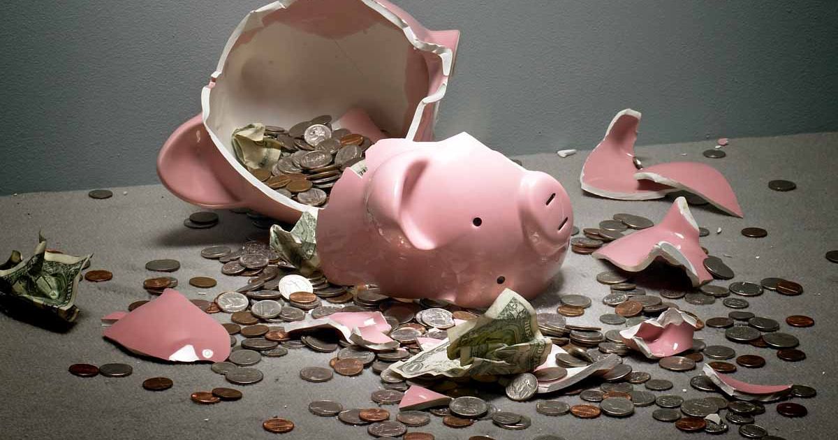 Broken-piggy-bank-with-money-spilling-out.jpg