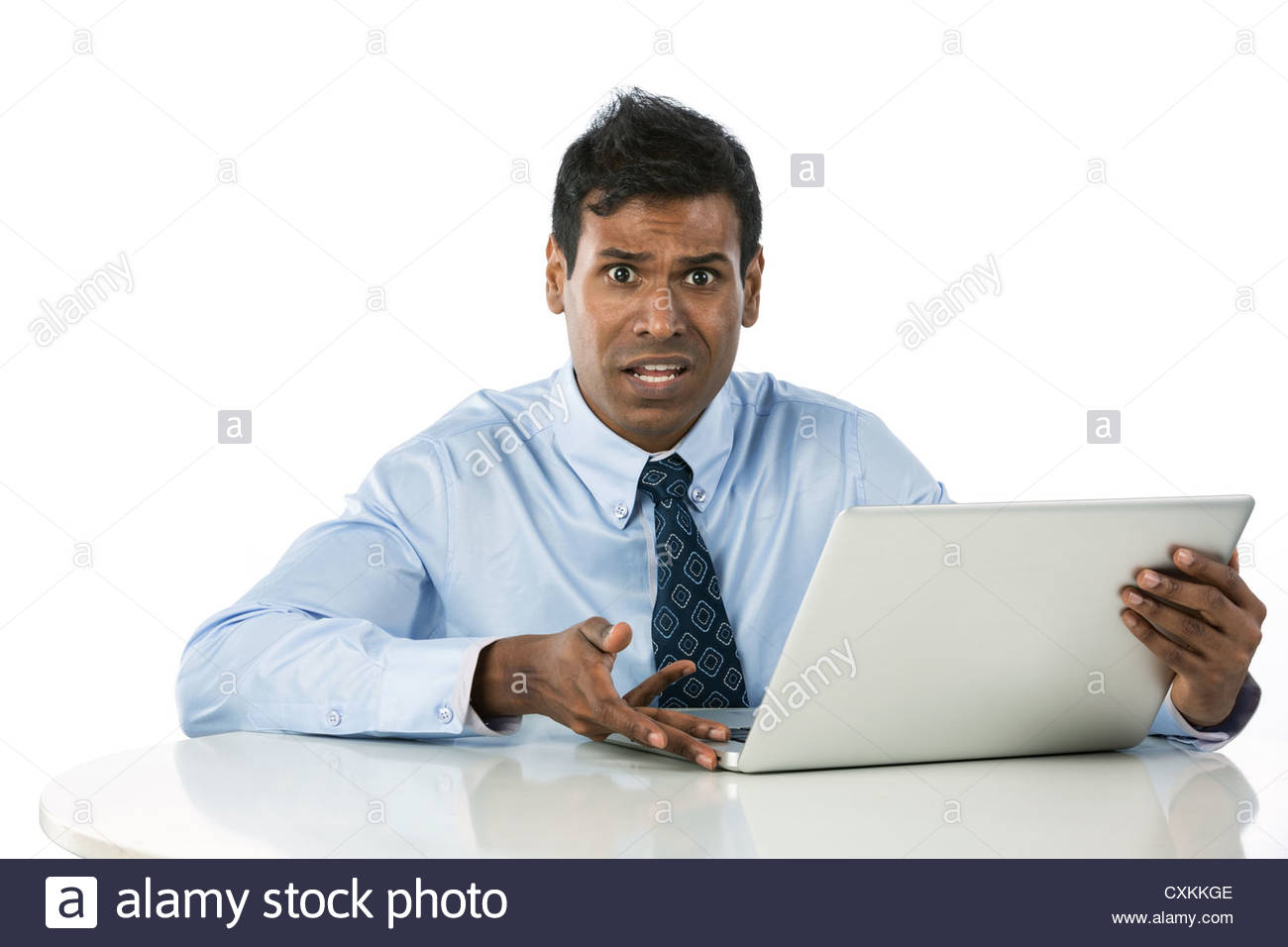 portrait-of-a-confused-indian-business-man-working-with-his-laptop-CXKKGE.jpg