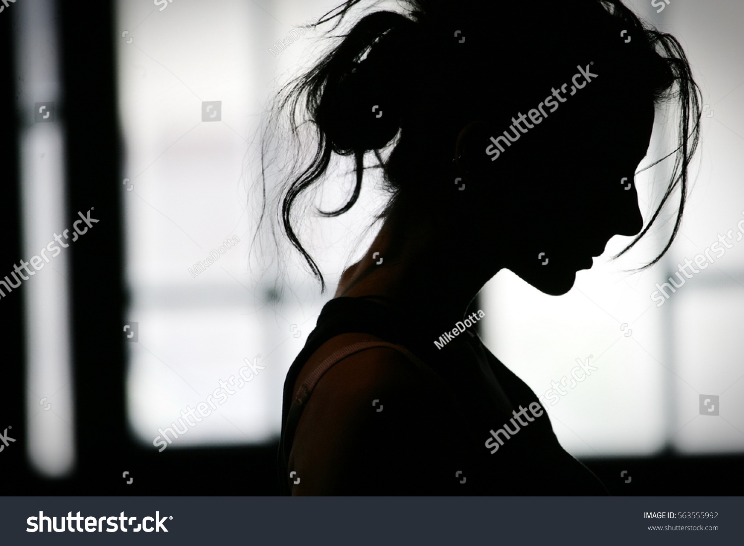 stock-photo-silhouette-of-woman-s-head-with-waving-hair-back-light-563555992.jpg