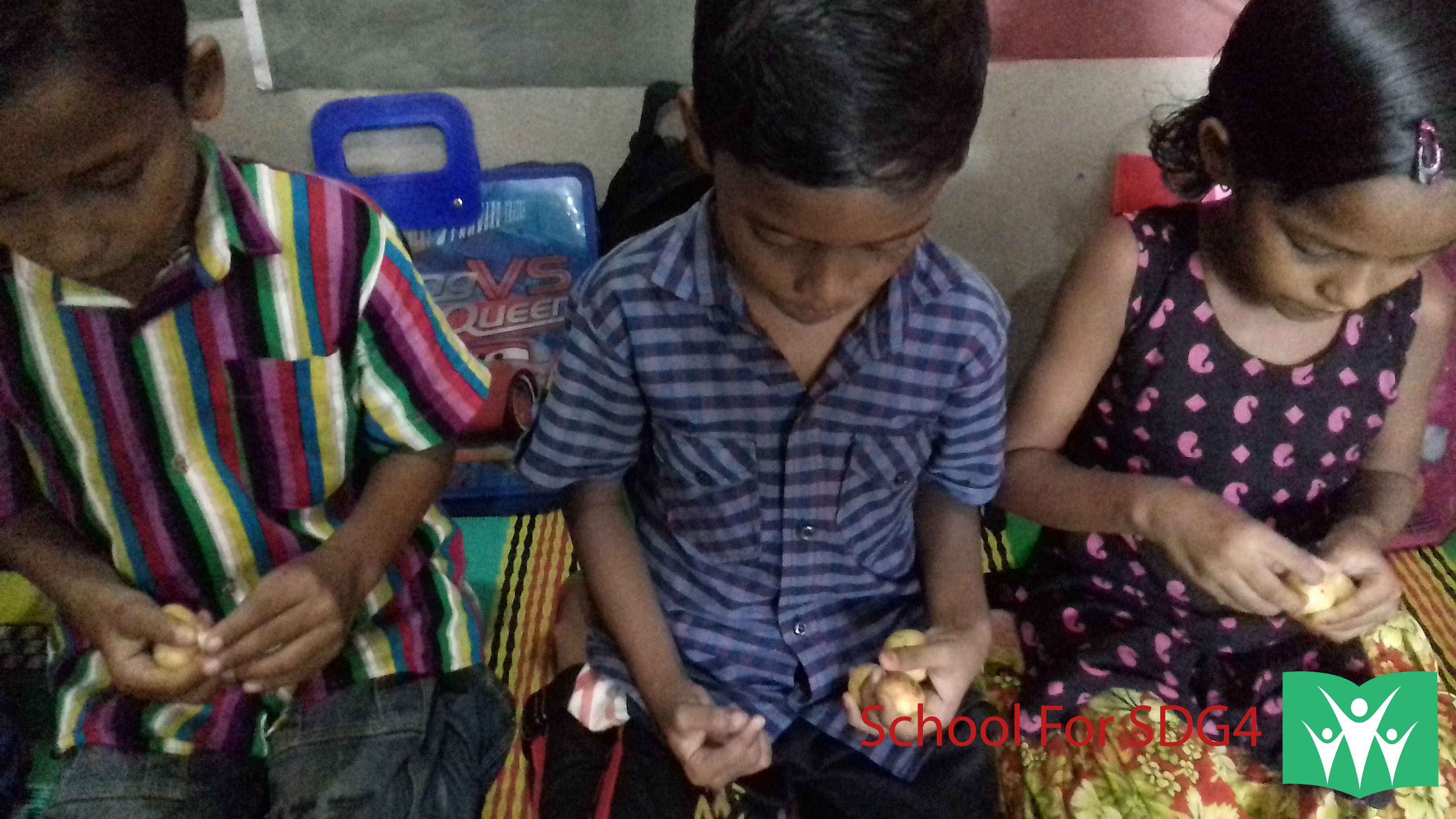 Children enjoying Lotkon fruits at school.jpg