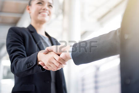 69101868-businesswoman-making-handshake-with-a-businessman-greeting-dealing-merger-and-acquisition-concepts.jpg