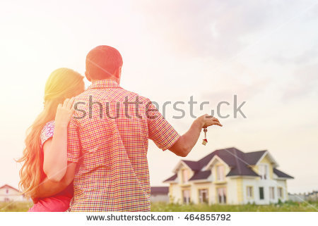 stock-photo-young-couple-standing-outside-dream-home-in-sunset-copy-space-464855792.jpg