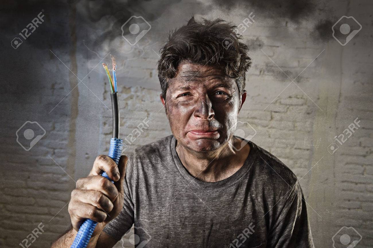 53337713-young-man-holding-electrical-cable-smoking-after-domestic-accident-with-dirty-burnt-face-in-funny-sa.jpg