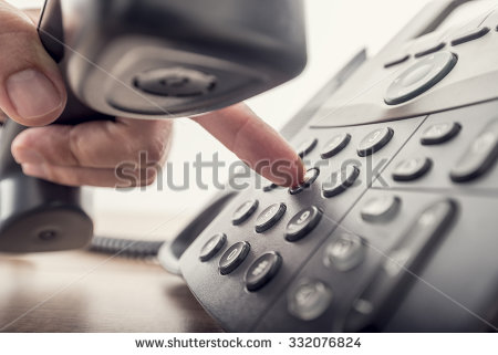 stock-photo-closeup-of-male-hand-holding-telephone-receiver-while-dialing-a-telephone-number-to-make-a-call-332076824.jpg