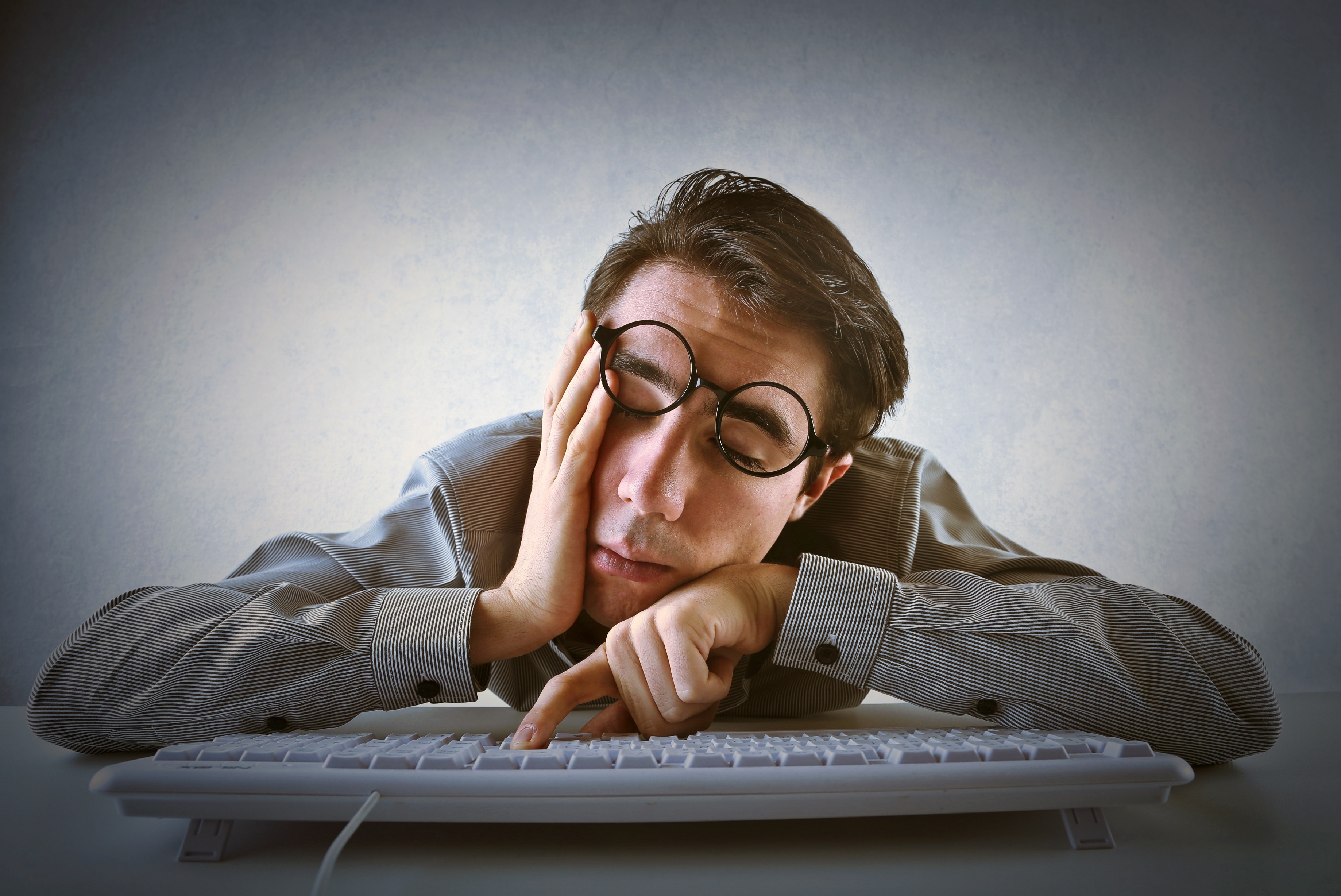 typical-programmer-sleeping-on-keyboard-tired-glasses-men-5861.jpg