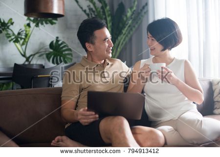 stock-photo-happy-asian-couple-looking-at-the-computer-and-relaxing-with-a-cup-of-coffee-794913412.jpg