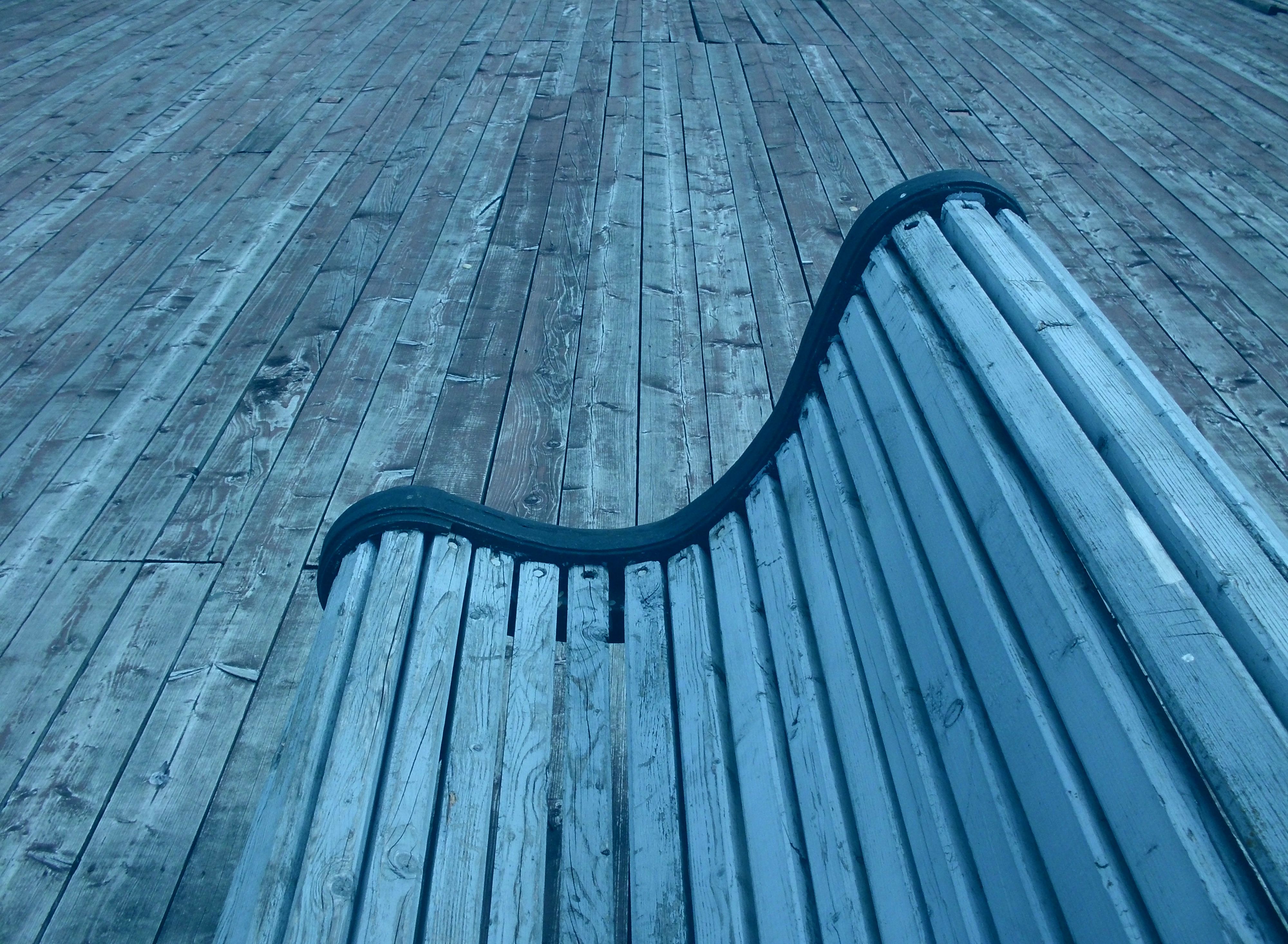 Park bench in perspective.Garden bench from close up. Wood material. Close up shot effect..jpg
