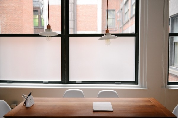 conference-table-with-chairs-and-lamps-with-windows-in-background.jpg