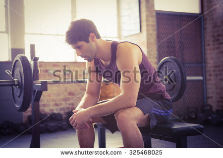 stock-photo-focused-man-sitting-on-the-bench-at-the-gym-325468025.jpg