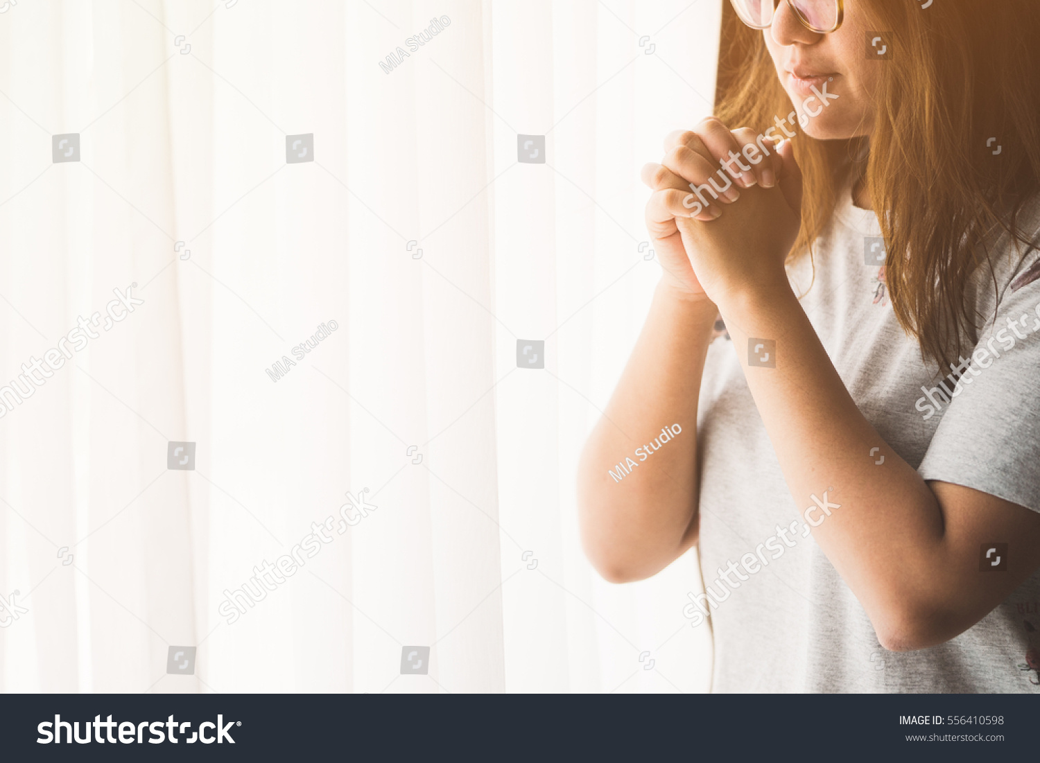 stock-photo-woman-praying-near-the-window-in-the-morning-teenager-woman-hand-praying-hands-folded-in-prayer-556410598.jpg
